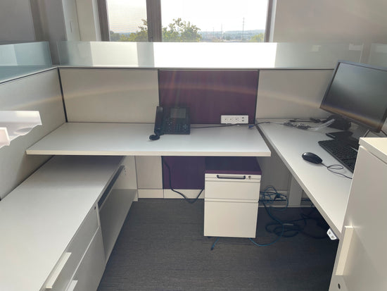 Picture of Herman miller canvas cubicle system with white and purple panels and rolling ped